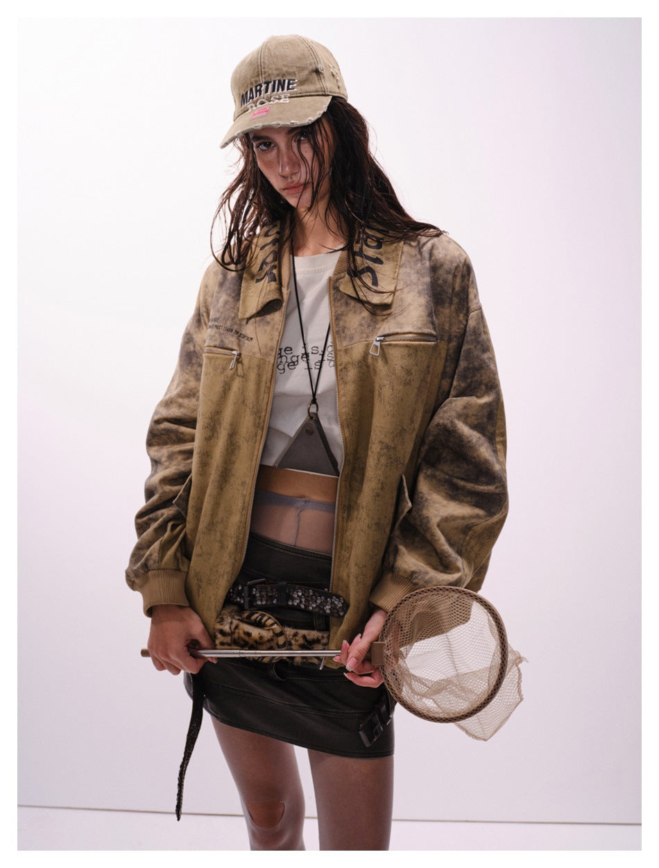 Closer view of a model in an open mottled tan-brown jacket with darker sleeves, zip pockets and a wide collar.
