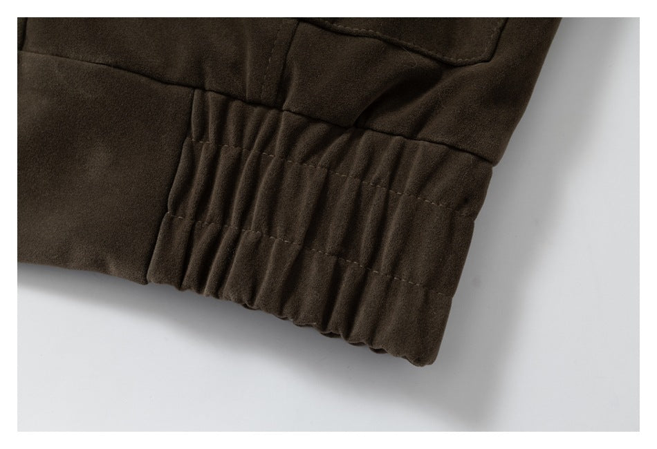 Close-up of a dark brown jacket's gathered elastic hem.