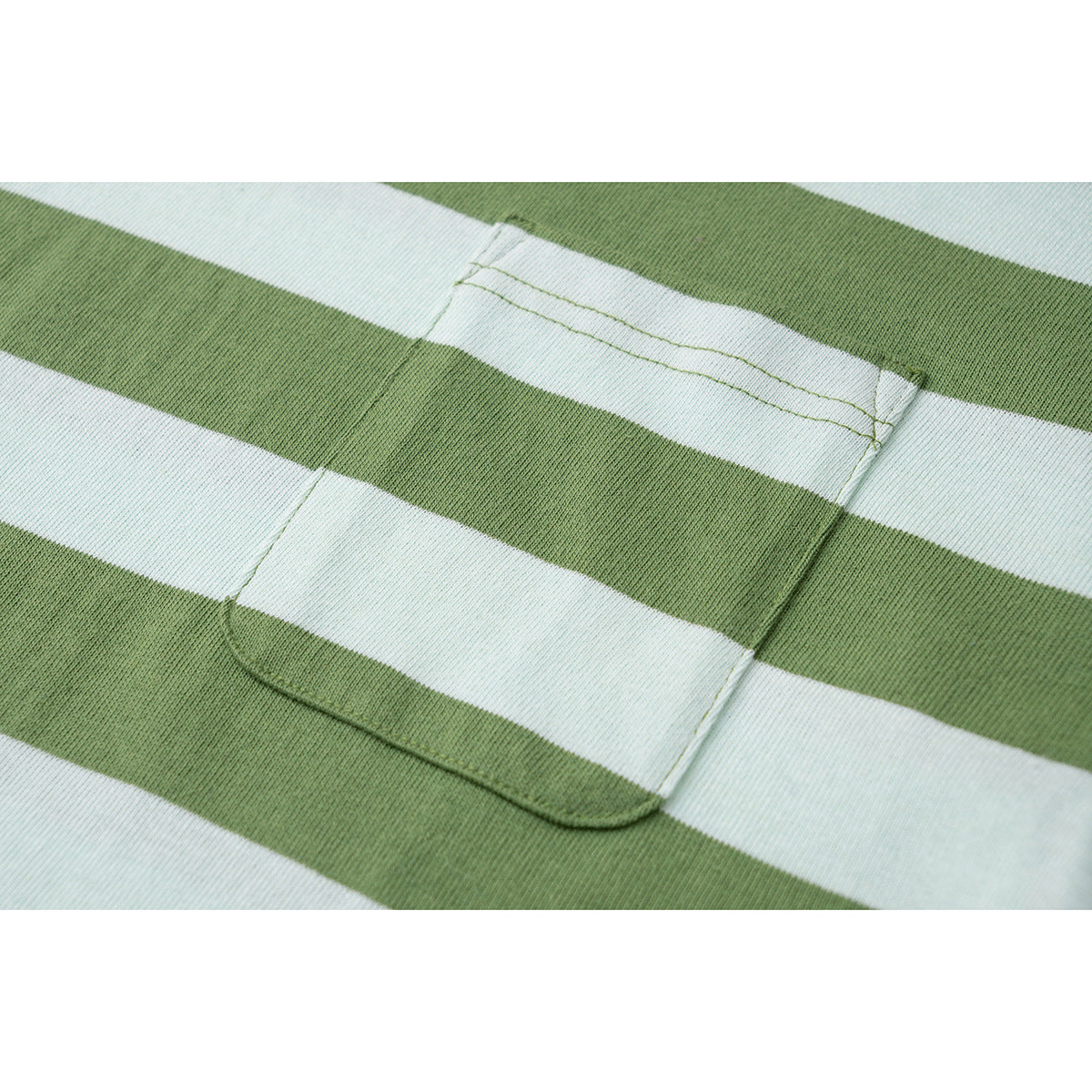 Close-up of a chest pocket on green-and-white striped T-shirt fabric.