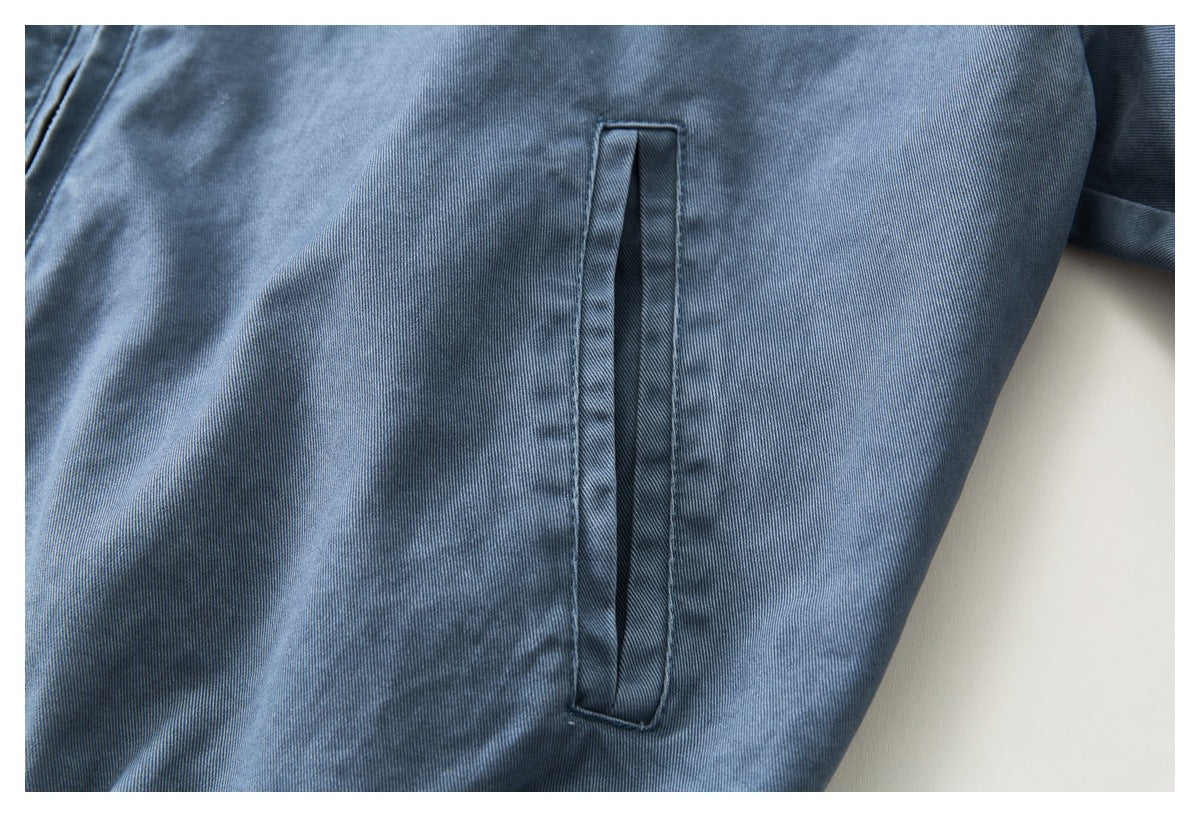 Close-up of a vertical welt pocket on a blue garment.