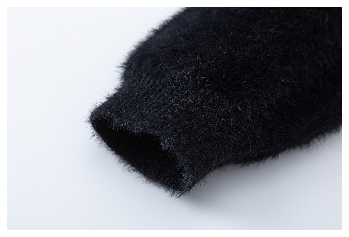 Close-up of a folded edge on black fuzzy fabric.