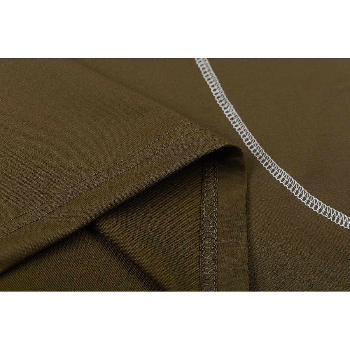 Close-up of olive-brown shirt fabric showing a folded hem, seam stitching, and white overlock stitching.