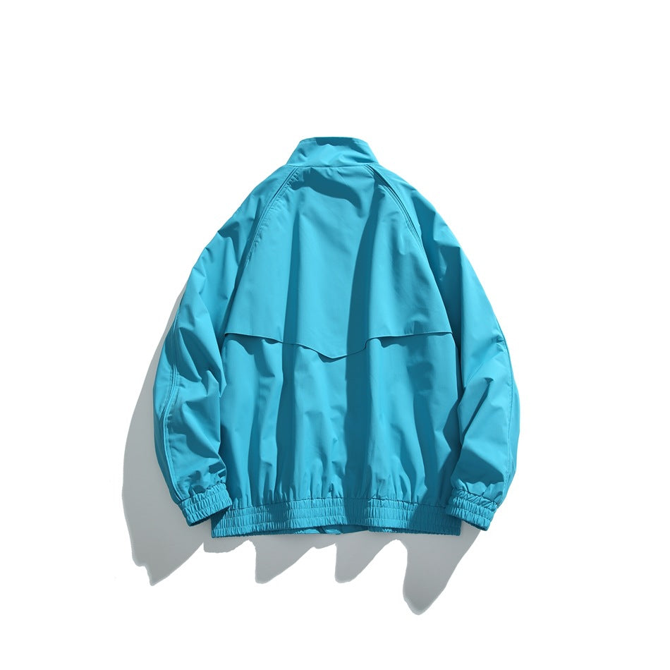 Back view of a turquoise jacket with a high collar, shoulder yoke, long sleeves, elastic cuffs and gathered hem.