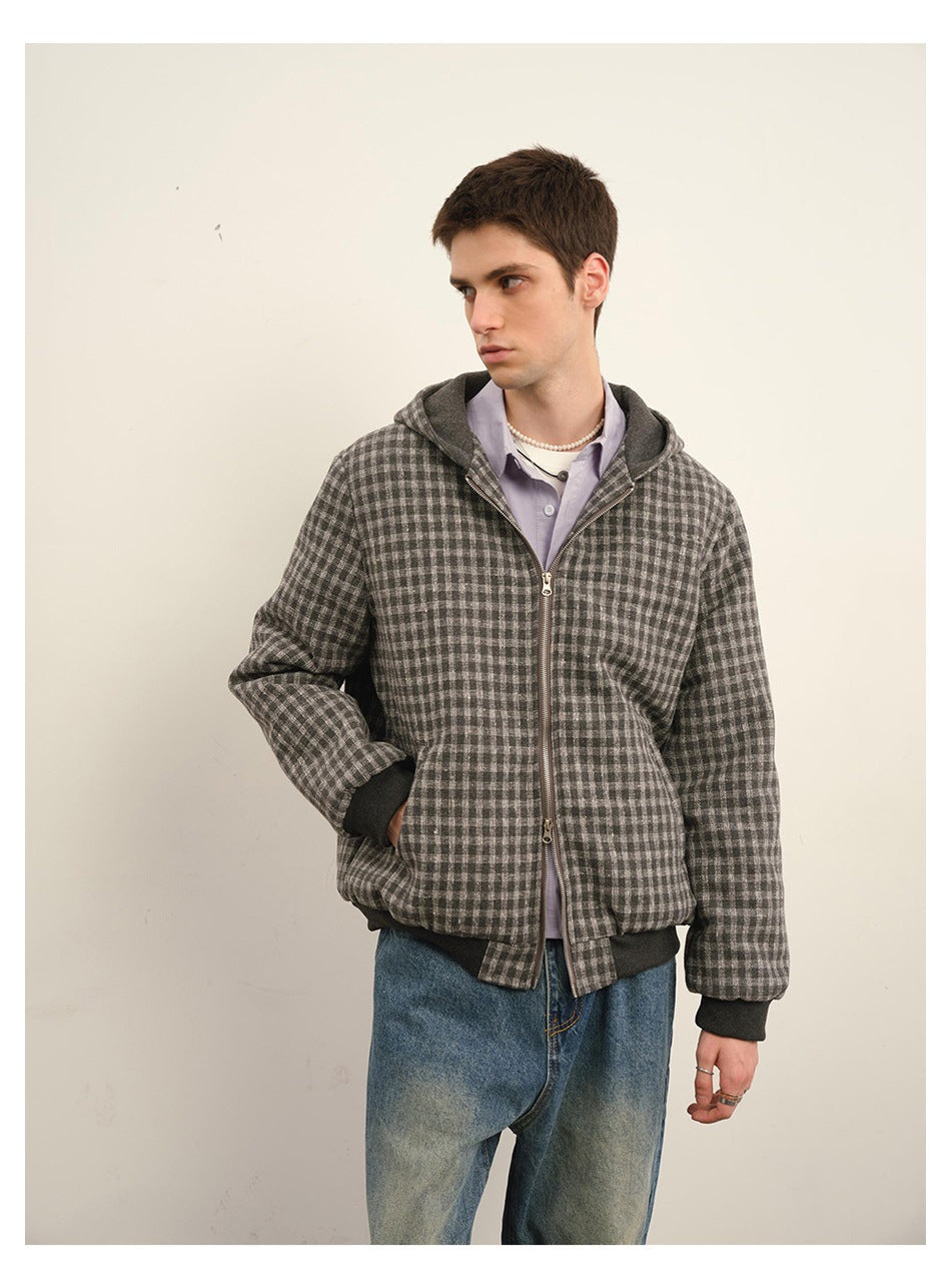 Model wearing a gray and black checkered zip-up hooded jacket with dark ribbed cuffs and hem.