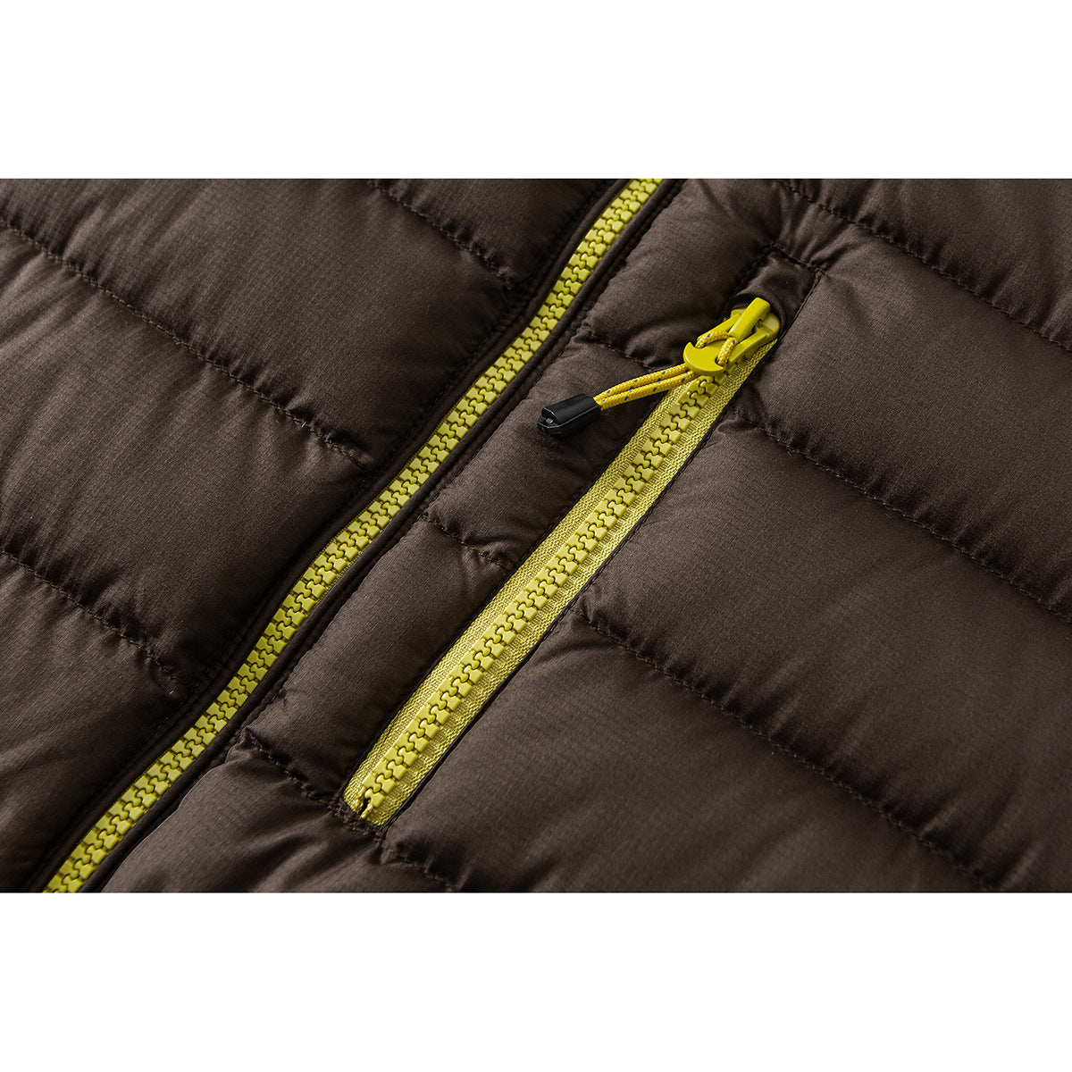 Close-up of a dark brown quilted jacket with bright yellow front and zippered pocket zippers.