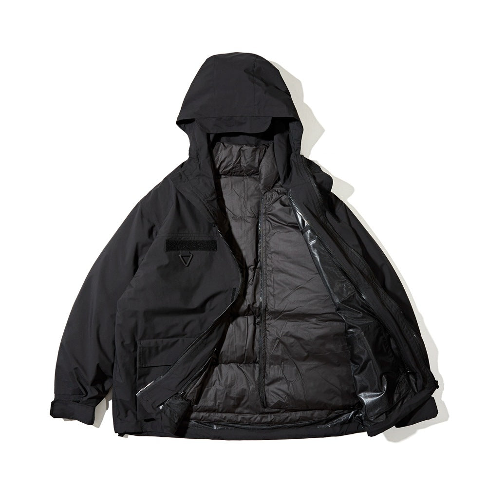 Black hooded jacket laid flat with the front open, showing the black quilted inner layer and chest patch