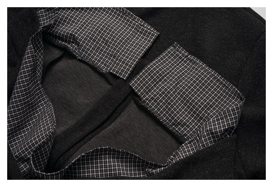 Close-up of the garment's inside neckline with black-and-white checked facing and charcoal fabric.