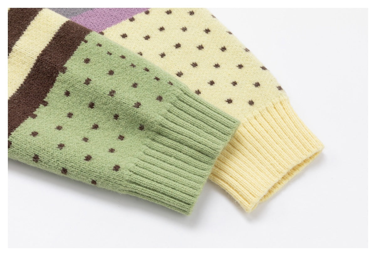 Overlapping knit sleeves in pale green and cream, patterned with small brown dots and finished with ribbed cuffs.