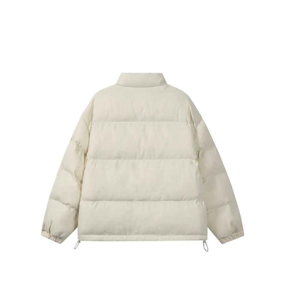 Back view of an ivory padded jacket with horizontal quilting, a stand collar, and adjustable hem loops.