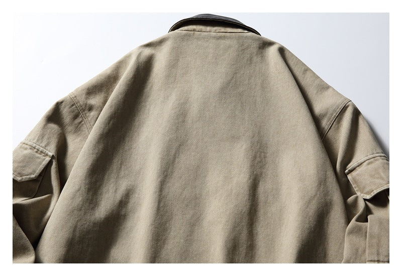 Back view of a taupe zip jacket with a plain panel and flap pockets on the sleeves.