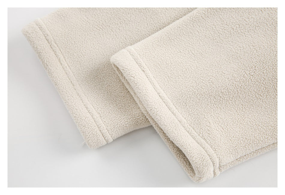 Close-up of cream loop-textured fabric folded to show its stitched edge.