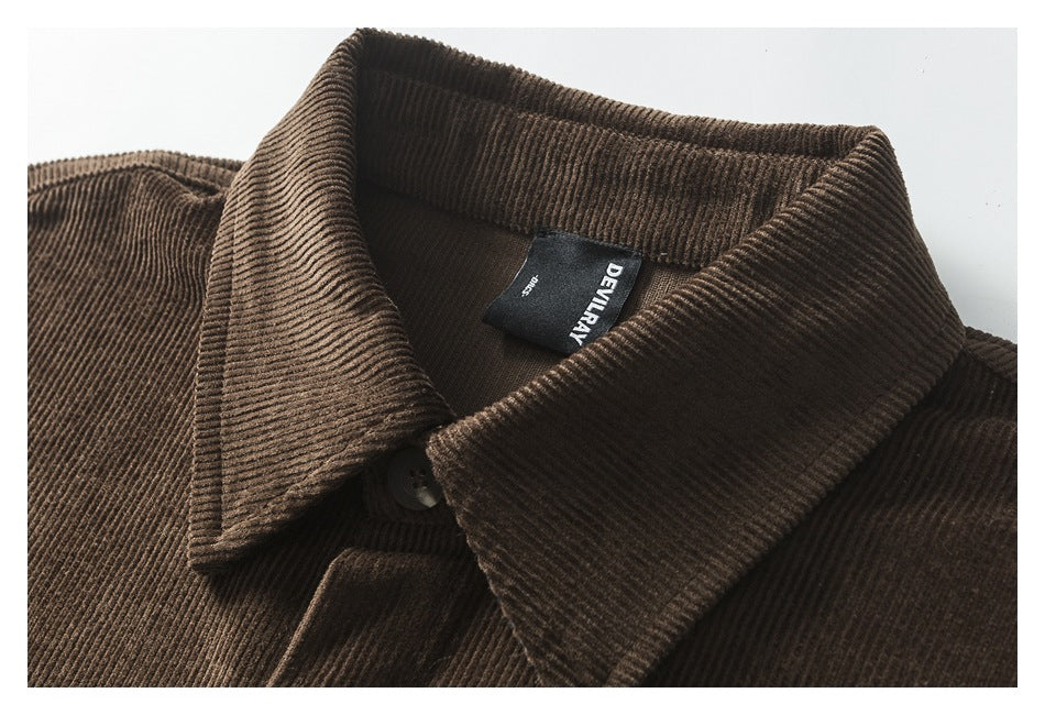 Close-up of the brown corduroy shirt's collar, top button and sewn-in DEVILRAY label.