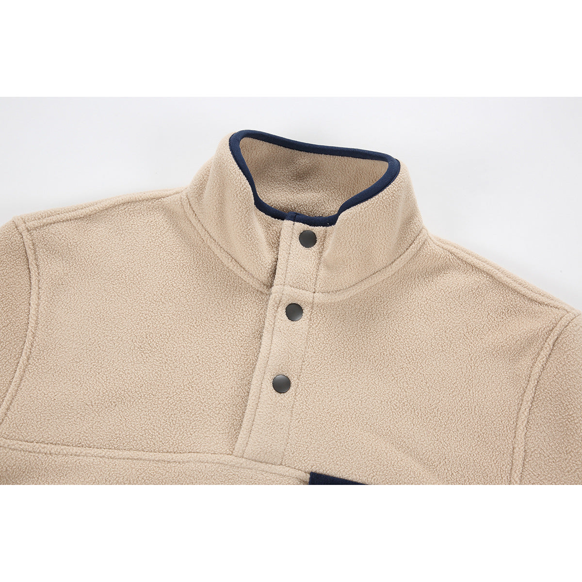 Close-up of a beige fleece pullover's stand collar, navy trim, and three dark snap buttons.