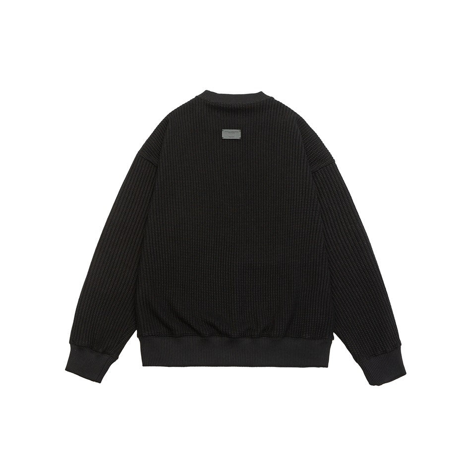 Back view of a black textured knit sweater with ribbed collar, cuffs, and hem on a white background.