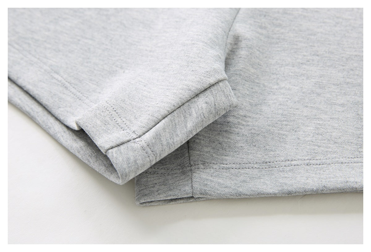 Close-up of the gray shorts’ folded leg hem and stitching.