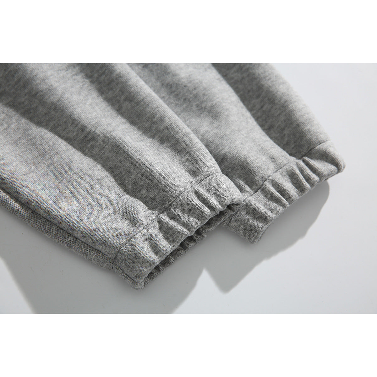 Close-up of the light gray hoodie’s gathered elastic sleeve cuffs.