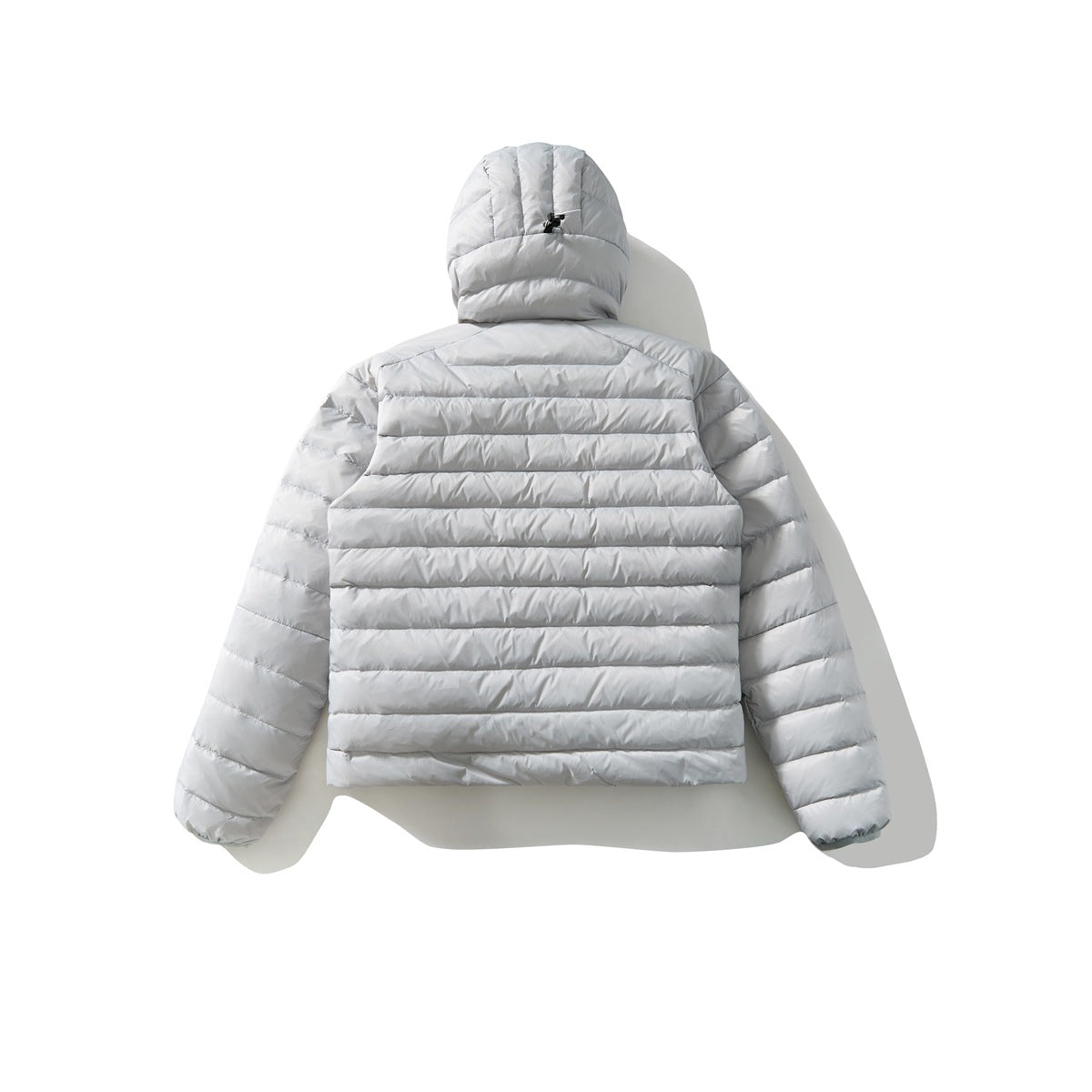 Back view of a light gray hooded puffer jacket with horizontal quilting and long sleeves, laid flat on white.