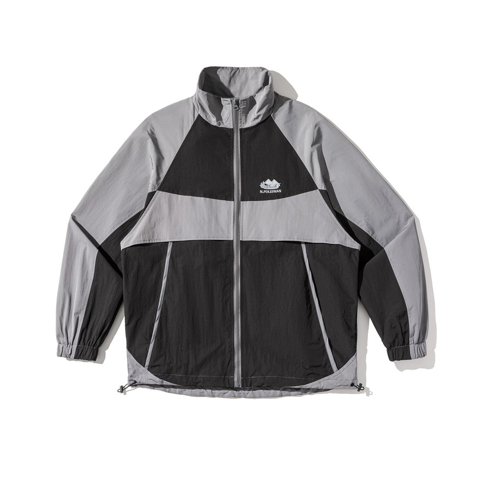 Black and gray color-block zip jacket with stand collar, raglan sleeves, and hem drawcords, flat front view
