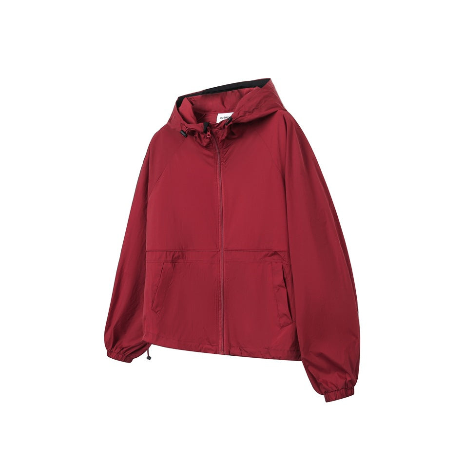 Red hooded zip-up jacket with drawcord hood, front pockets and elastic cuffs, shown from a three-quarter front angle