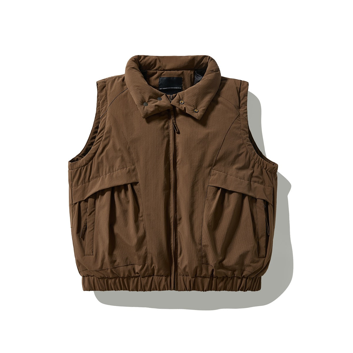 Front view of a brown sleeveless vest with a snap collar, center zipper, large flap pockets, and gathered hem.