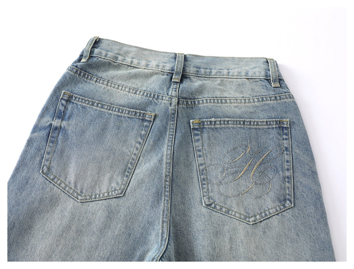 Back view of light blue faded jeans with two pockets, belt loops and stitched detailing on one pocket.