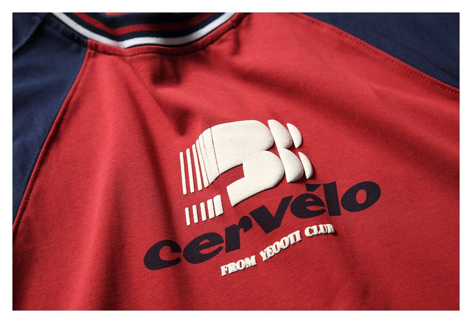 Close-up of a red shirt chest with a raised white and navy Cervélo graphic and striped neckline.