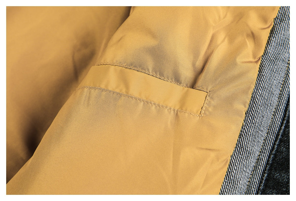 Interior close-up showing a mustard garment seam and stitched rectangular detail beside dark textured fabric.