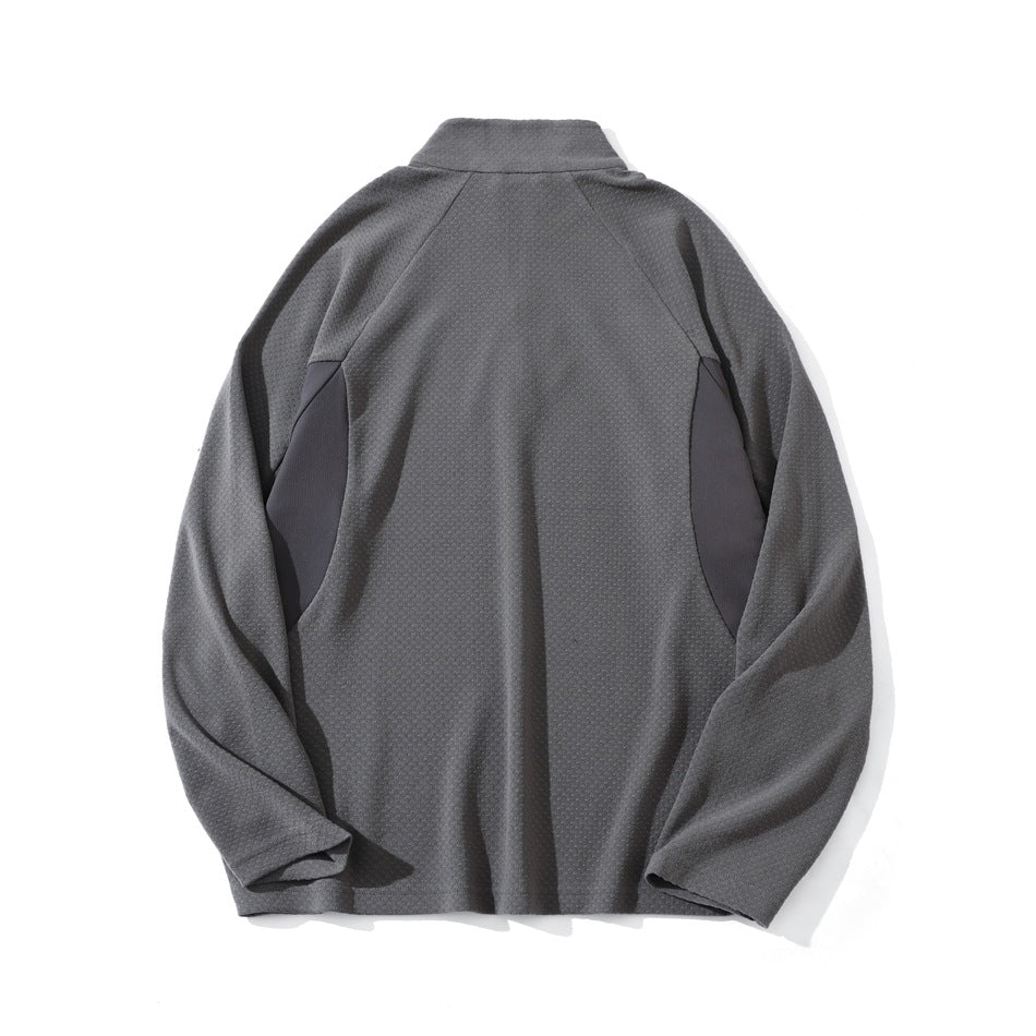 Gray pullover laid flat, back view, with a stand collar, raglan sleeves, and contrasting side panels.