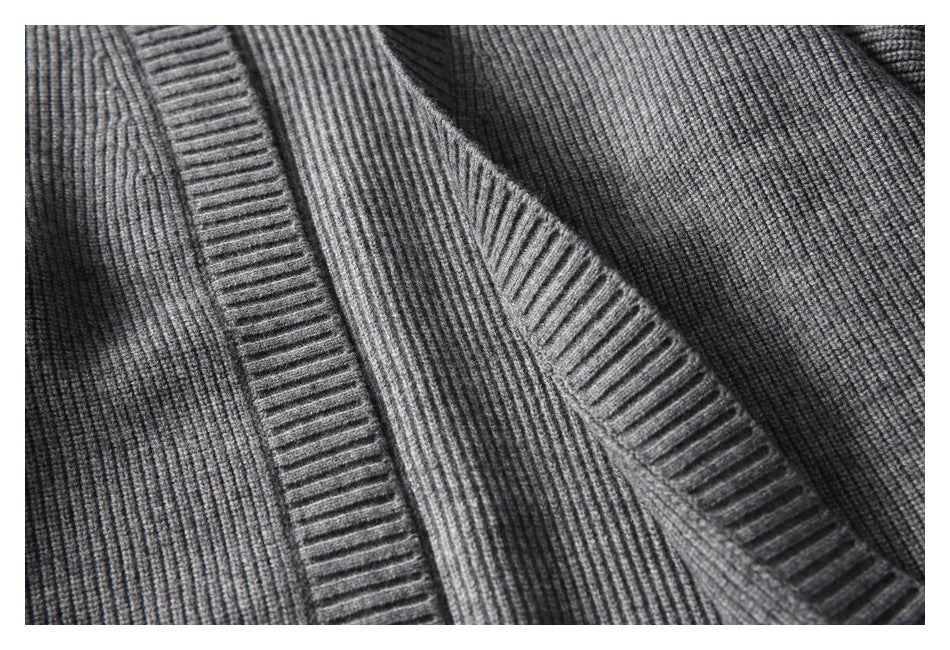 Close-up of the gray cardigan's overlapping open front and broad ribbed edge.