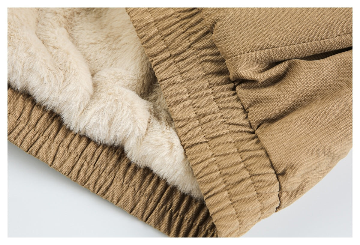 Close-up of a tan garment edge with cream faux-fur lining and a gathered elastic seam.