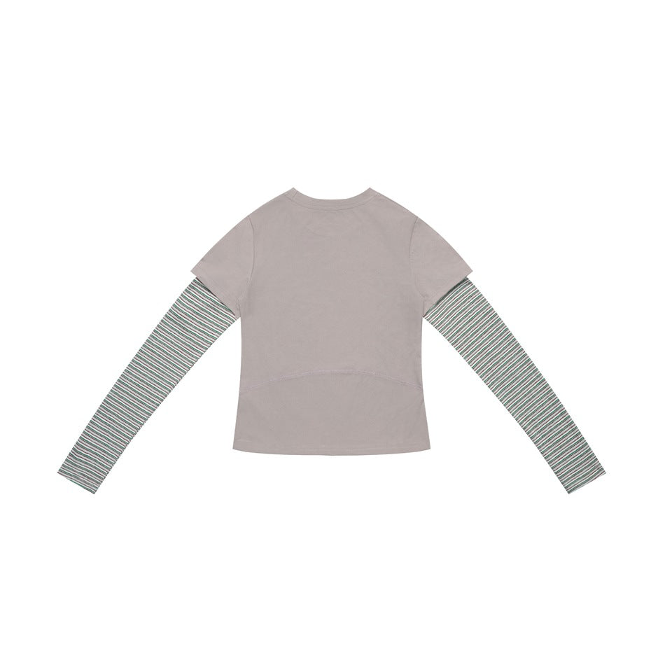Back view of a taupe short-sleeve top layered over long sleeves with thin green stripes.