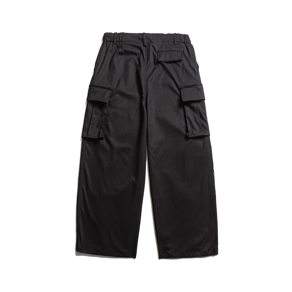 Back view of black wide-leg cargo pants with flap pockets at the sides and rear.