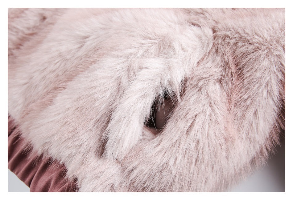 Close-up of pale pink faux fur around a small opening that reveals dark fabric underneath.
