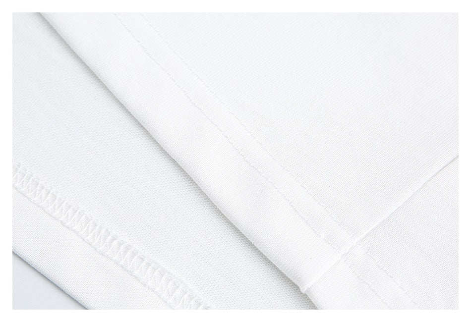 Close-up of white garment fabric showing stitched and overlocked seams.