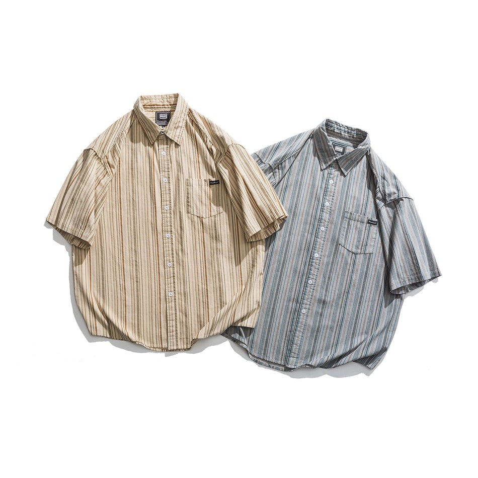Two short-sleeve button-up shirts displayed together: one beige with brown stripes and one gray with blue stripes.