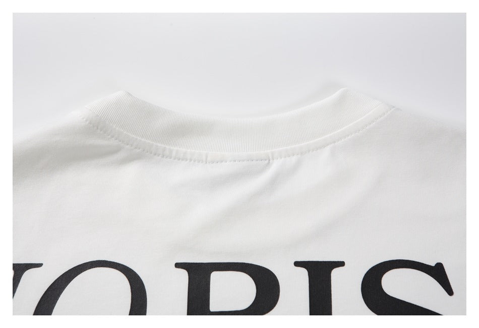 Close-up of the white T-shirt's back neckline with part of its large black print visible below.
