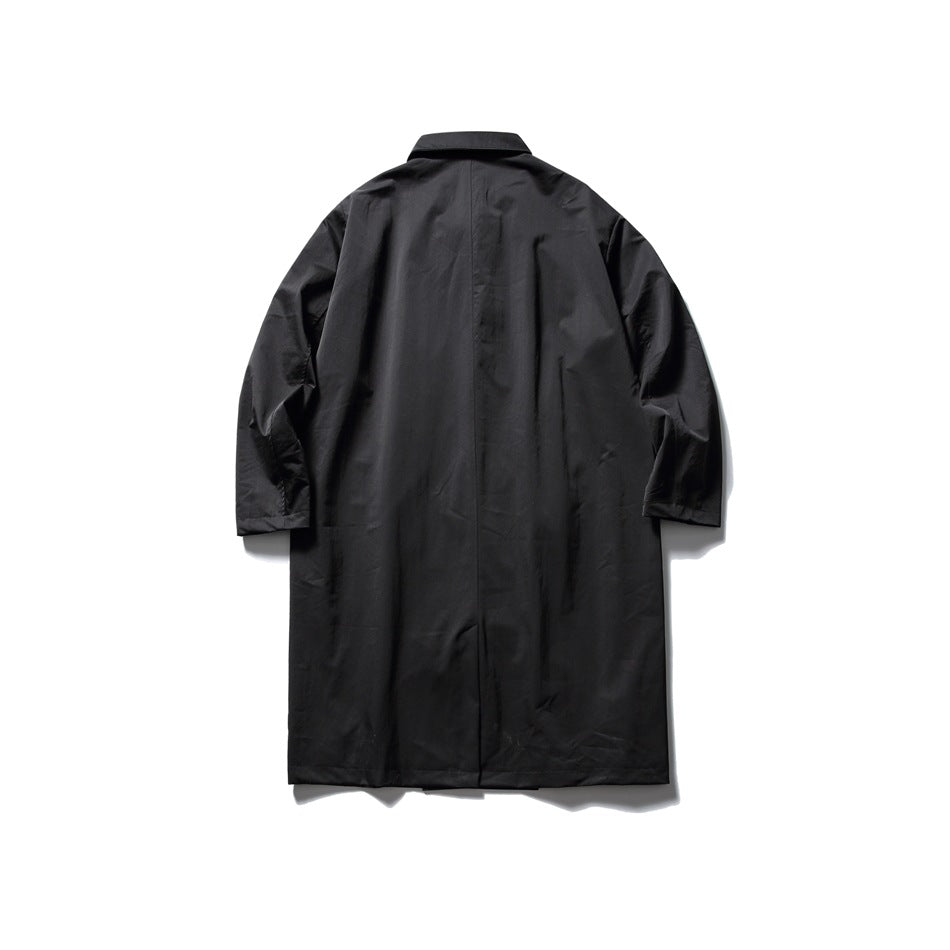 Full-length rear view of a black long coat with a center seam and straight hem, laid flat on white.