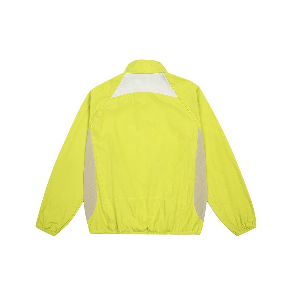 Back of a bright lime jacket with a white upper-back panel and gray side inserts.