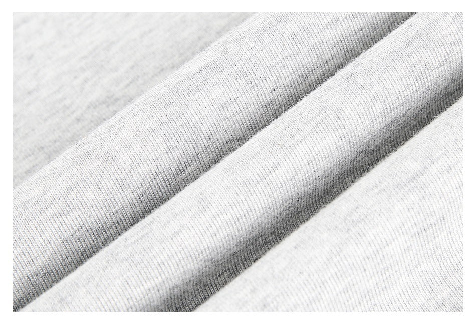 Extreme close-up of heather gray knit fabric gathered into soft folds.