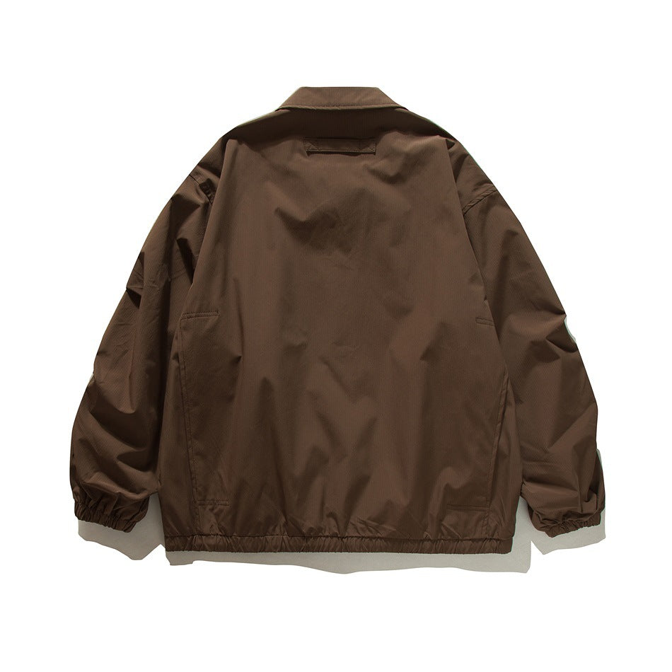 Brown coach-style jacket flat lay, back view with plain back panel, elastic cuffs and elastic hem
