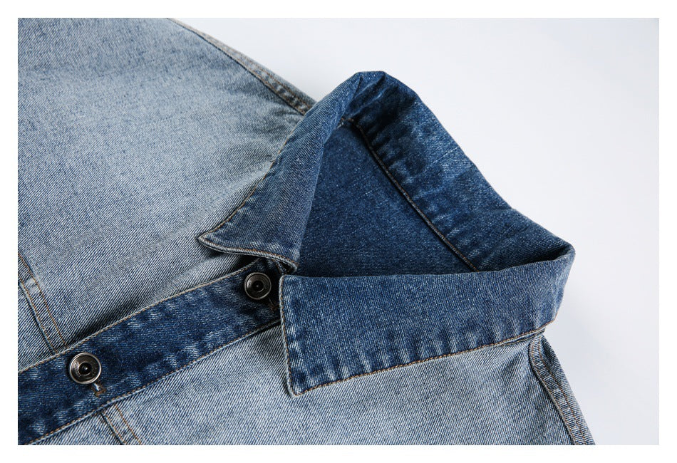 Close-up of the denim jacket's contrasting dark collar and buttoned front placket.