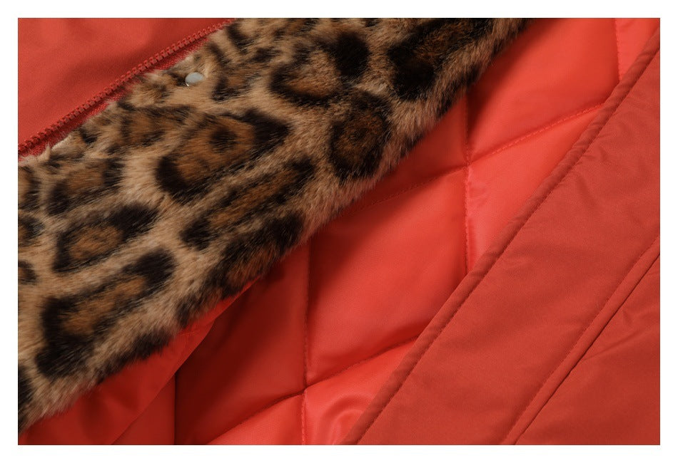 Close-up of rust-red jacket lining with a brown-and-black leopard-print panel and quilted stitching.