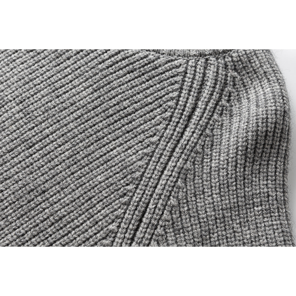 Close-up of the gray sweater's ribbed knit and shoulder seam.