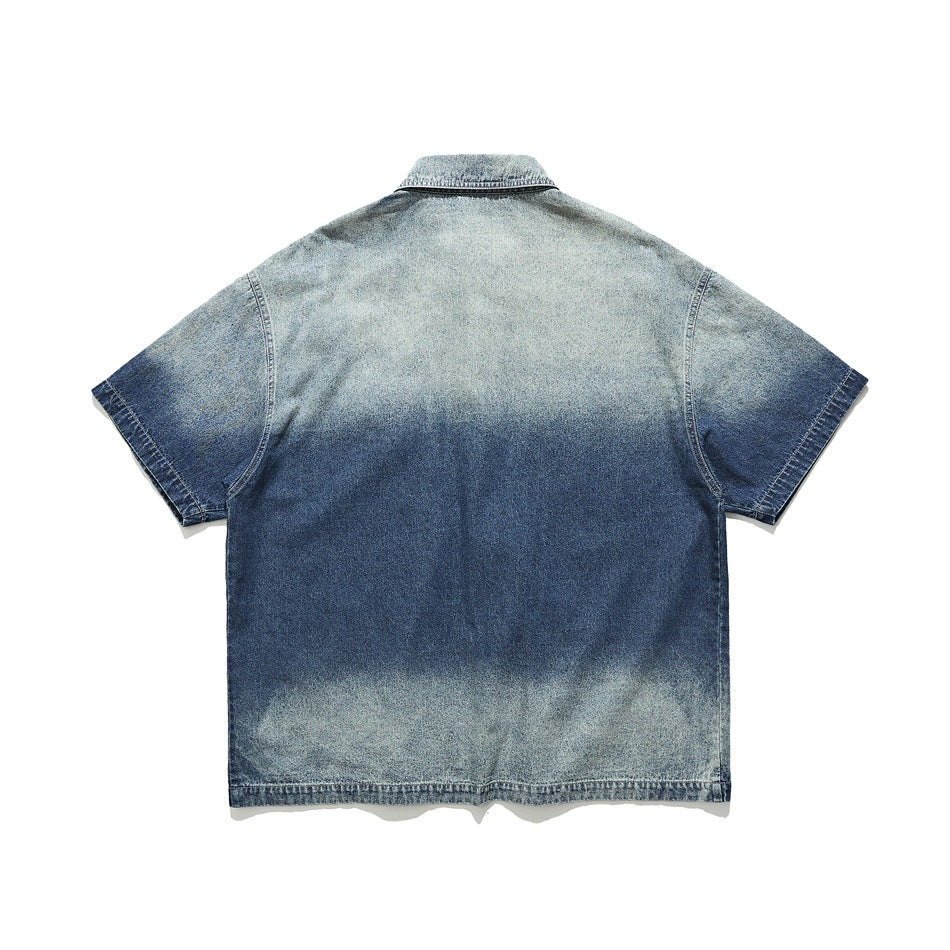 Back view of a short-sleeve blue denim shirt with a light-to-dark washed finish, laid flat on white.