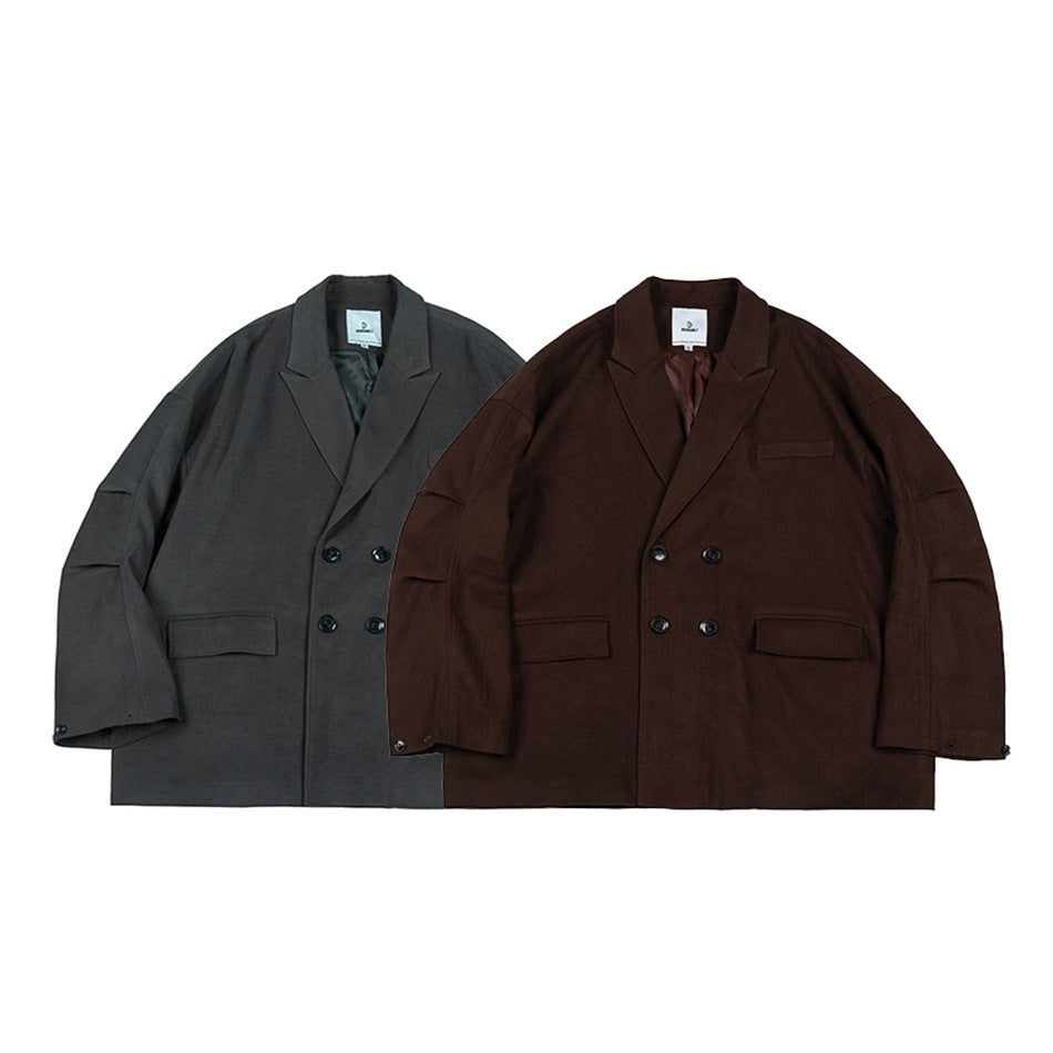 Front view of two oversized double-breasted blazers, one charcoal gray and one dark brown.