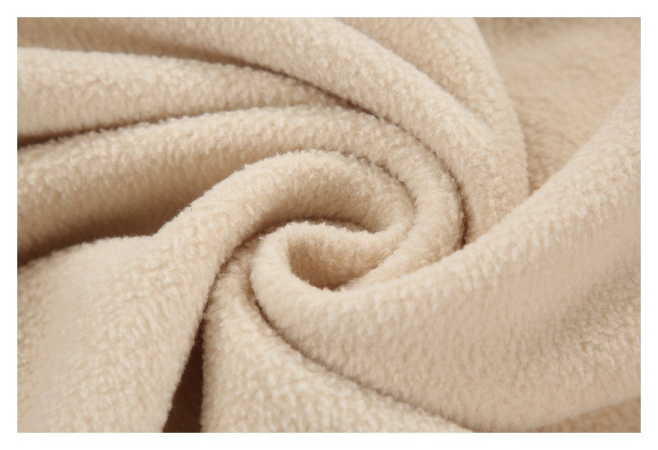 Cream-colored plush fabric shown gathered into a spiral fold.