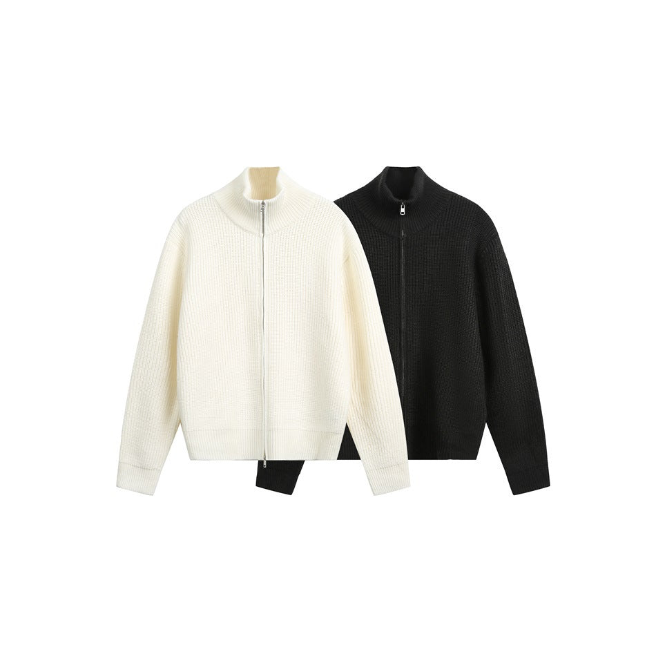 Two ribbed zip-front sweaters shown together: one ivory and one black, both with high collars.