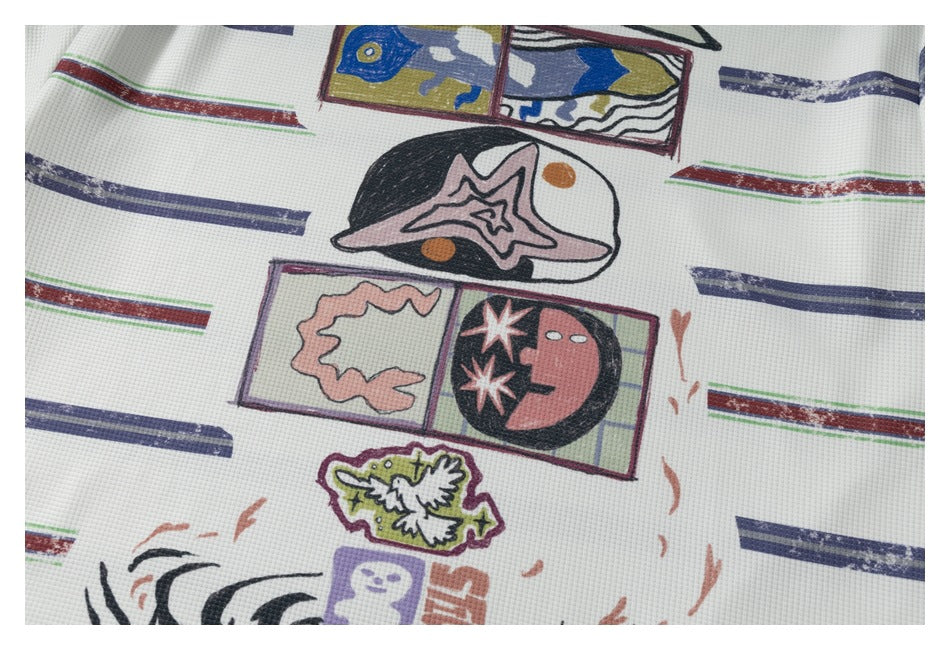Close-up of colorful illustrated graphics and distressed stripes printed on the white polo.