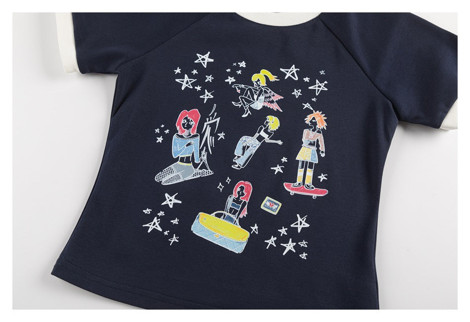 Flat lay of a navy short-sleeve shirt with cream trim and colorful character illustrations among white stars.