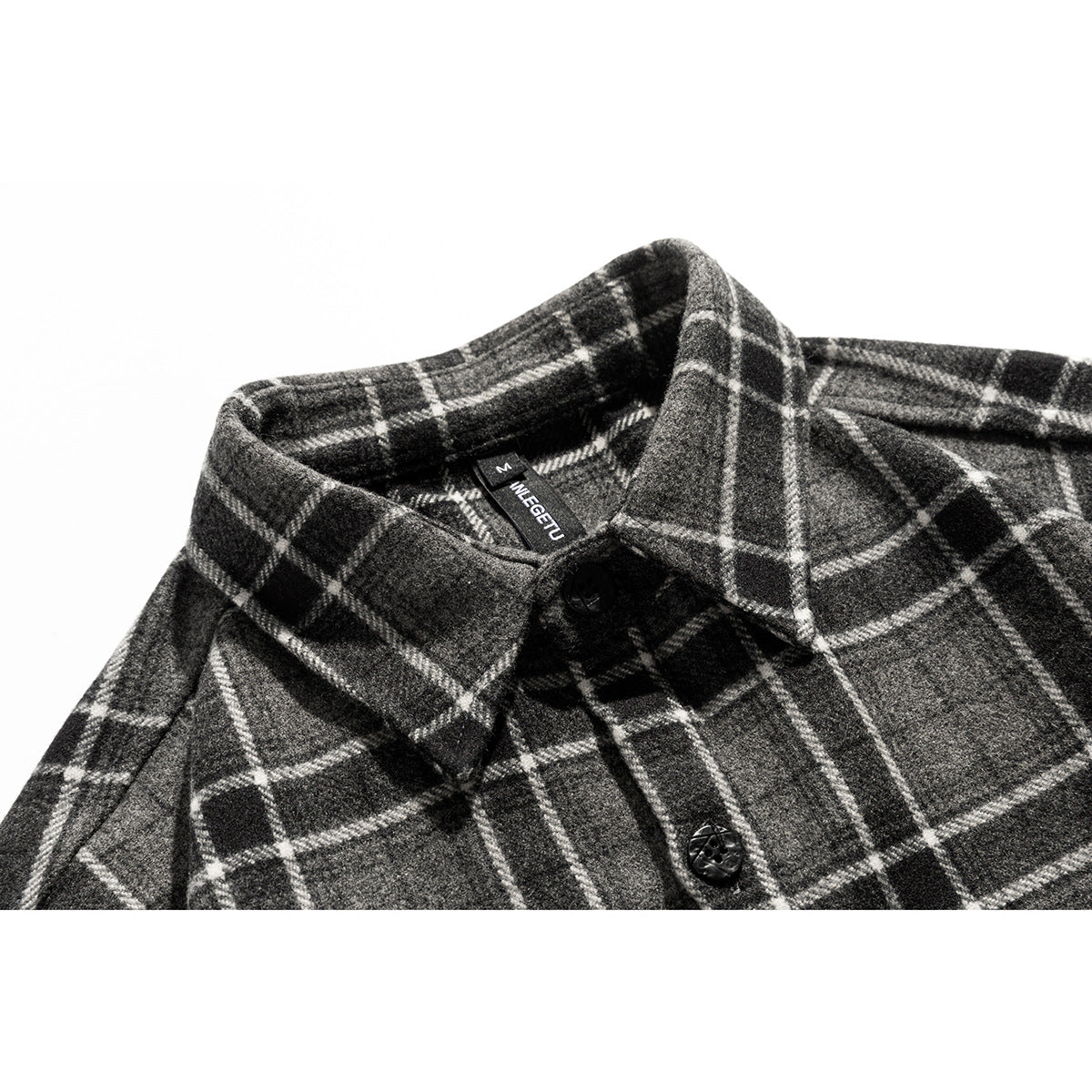 Close-up of a charcoal gray plaid shirt collar, black buttons, and a visible neck label.